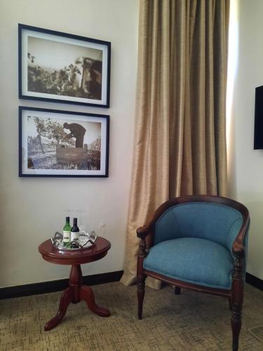 a room with a blue chair and a table at Meerendal Boutique Hotel in Durbanville