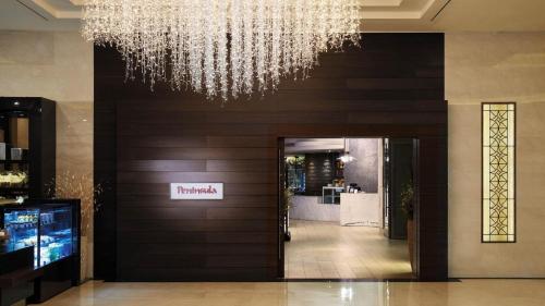 a chandelier hanging over a hallway in a building at Lotte Hotel Ulsan in Ulsan