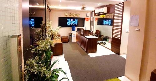 een salon met een wachtkamer met planten erin bij Hotel Heritage - Near Trade Center, Visa Consulate BKC in Mumbai