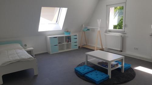 a bedroom with a bed and a table in it at Ferienwohnung Höchberg in Höchberg