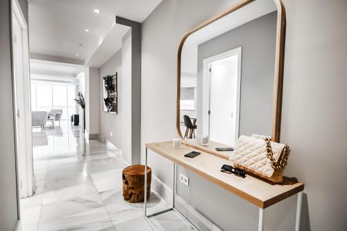 a bathroom with a mirror and a dressing table at Paseo in Almería