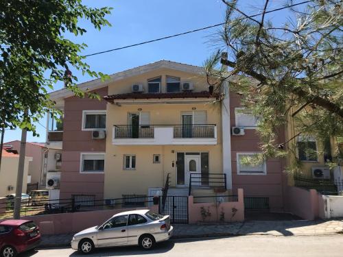 a white car parked in front of a house at georgia's cozy rooms #2 in Kavala