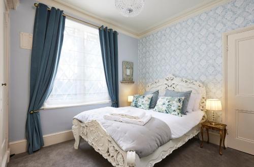 a bedroom with a white bed and a window at The Spa Chalet Scarborough Hot tub, pool, gym, beach location in Scarborough