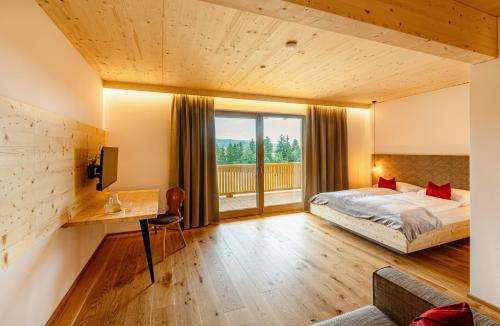 A bed or beds in a room at Pircherhof - Adults Only am Biobauernhof