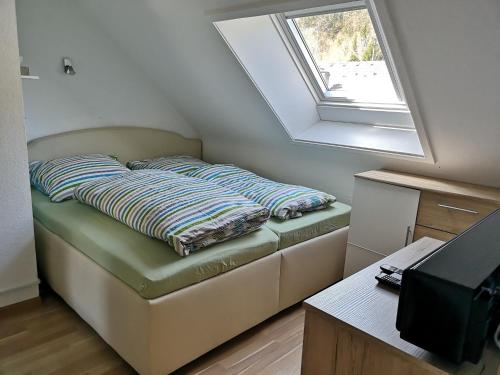 a couch in a room with a window at Schwalbennest - a69066 in Menzenschwand-Hinterdorf