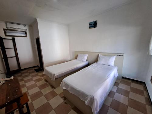 Letto o letti in una camera di Surfers Beachfront Lombok