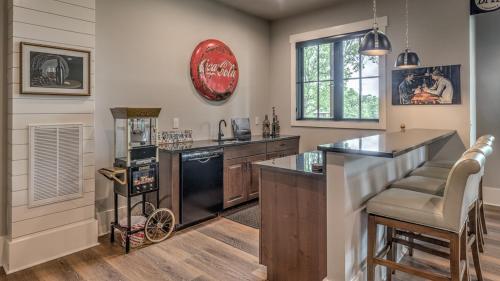 a kitchen with a black refrigerator and a counter at Bunker Down in Mineral Bluff