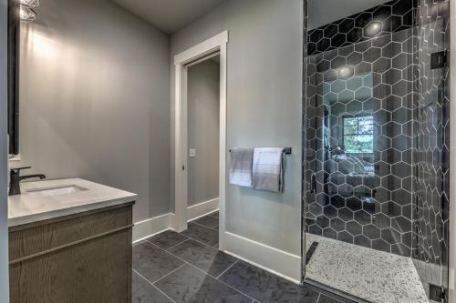 a bathroom with a shower and a sink at Bunker Down in Mineral Bluff