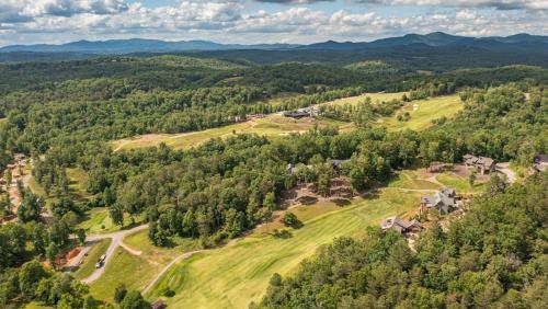 an aerial view of a house on a hill with trees at Bunker Down in Mineral Bluff