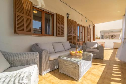 a living room with a couch and chairs and a table at Ca na Clar in Sa Ràpita