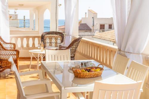 a table with a basket of fruit on a balcony at Ca na Clar in Sa Ràpita