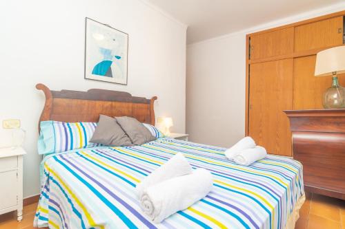a bedroom with a bed with towels on it at Ca na Clar in Sa Ràpita
