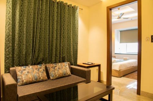 a living room with a couch and a bedroom at Hotel Dream Inn in Rishīkesh