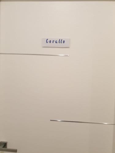 a white refrigerator with a sign that reads corolla at Blue Lagune Taormina Mare in Taormina