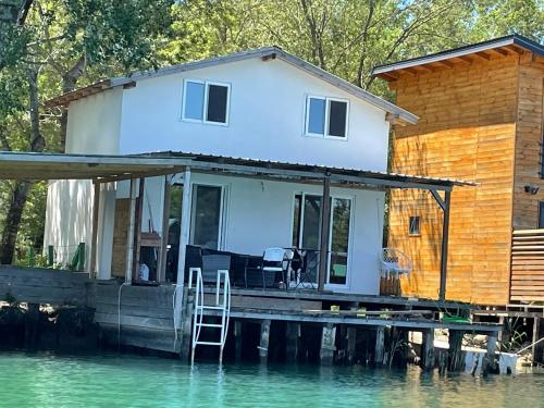 a house on a dock on a body of water at Pearl Cottage Ada Bojana in Ulcinj