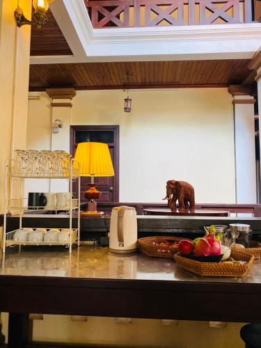 a kitchen with a table with fruit on it at Luang Prabang Maison Vongprachan & Travel in Luang Prabang