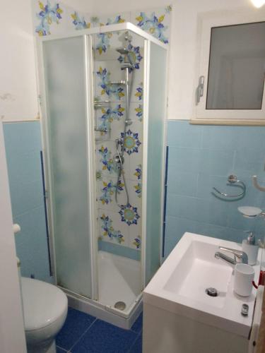 a bathroom with a shower and a sink and a toilet at Little House Forio in Forio d'Ischia