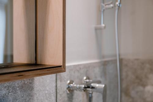 a bathroom with a shower with a glass door at Hotel Müllers Self-Check-In in Arbon