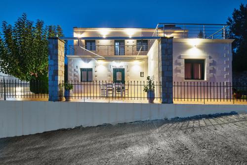 a house with lights on the front of it at Villa Elia by PosarelliVillas in Vryses