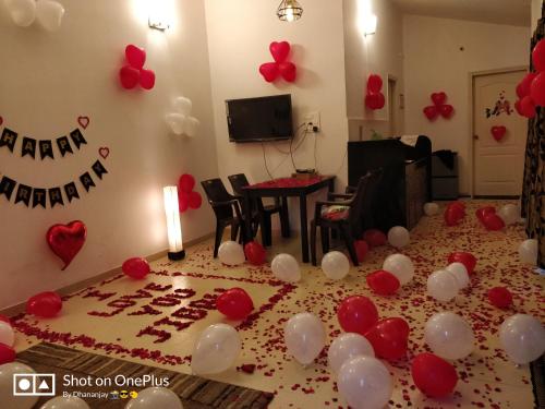 a room with a table with red and white balloons at Chalet Casa Amor, Perfect home amidst tranquility in Karjat