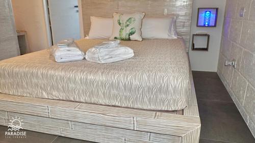 a large bed with towels on top of it at Paradise Sea Terrace in Monopoli