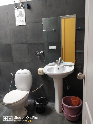 a bathroom with a toilet and a sink at Chalet Casa Amor, Perfect home amidst tranquility in Karjat