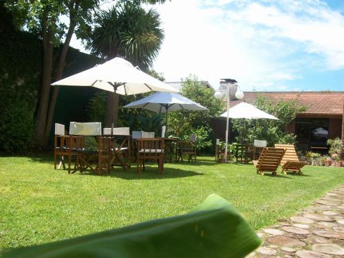 a group of tables and chairs with umbrellas at Hotel Turingia in Miramar