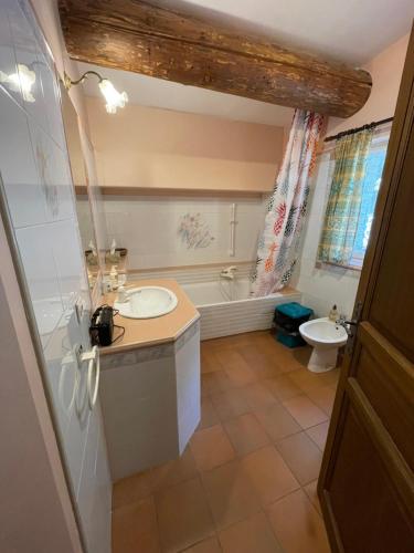 une salle de bain avec un lavabo, une baignoire et des toilettes dans l'établissement Maison Zouz, à Murs