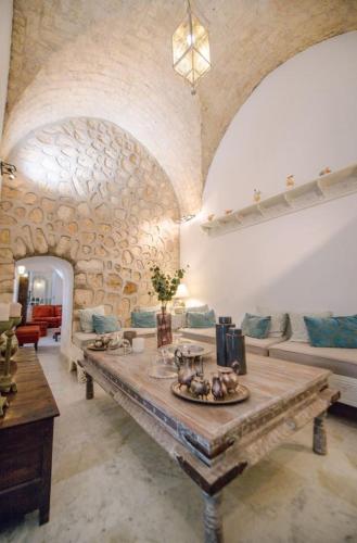 a large living room with a large wooden table at Dar Benti in Monastir