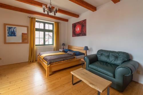 - un salon avec un canapé et une chaise dans l'établissement Apartment Sirius F in center of CB, à České Budějovice