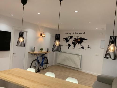 a room with a table and a map of the world on the wall at APARTAMENTOS SANTULLANO 2 in Oviedo