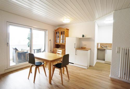 a kitchen and dining room with a table and chairs at Höllkopf - Stubenhof, Black Forest in Simonswald