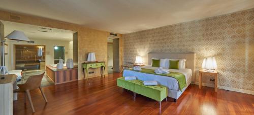 a bedroom with a bed and a living room at Relais Santo Stefano in Sandigliano