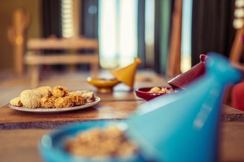 a table with a plate of food on a table at Oasis212 Dakhla in Dakhla