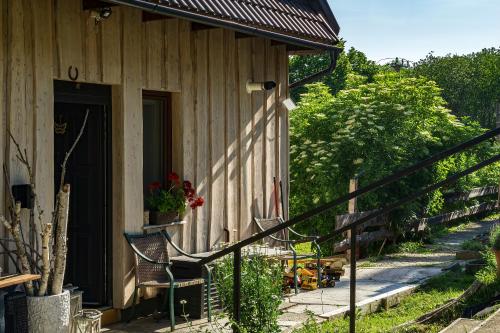 a porch of a house with a bench and a door at Mantara Vendégház in Matraszentlaszlo