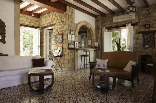 a living room with a couch and a table at Incirliev - Special Category in Alaçatı