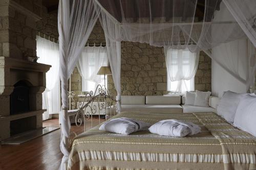 a bedroom with a bed with a canopy at Incirliev - Special Category in Alaçatı