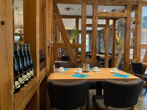 a dining room with a wooden table and chairs at MOSELTEL Ernst,Cochem in Ernst