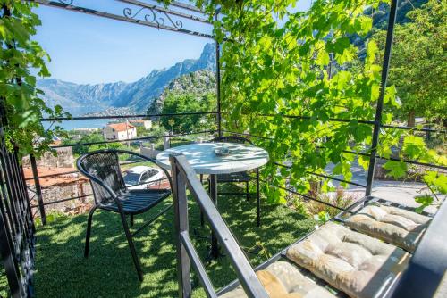 a balcony with a table and chairs and a view at Apartments Golden View in Kotor
