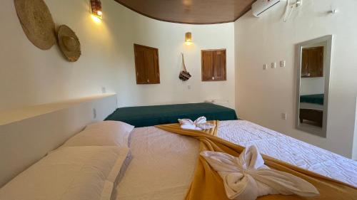 a bedroom with a bed with flowers on it at Oka Pousada Atins in Atins