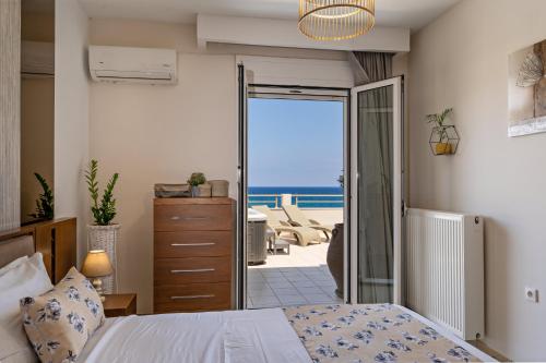 a bedroom with a bed and a view of the ocean at View Sea Apartment in Rethymno