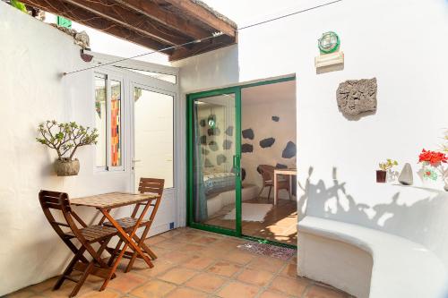a patio with a table and two chairs and a table at El Sitio in Frontera