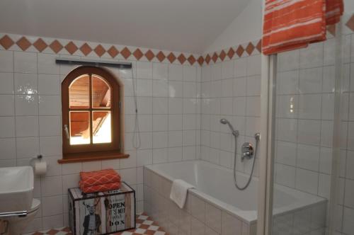 ein Bad mit einer Badewanne und einem Fenster in der Unterkunft Apartments-Weberlandl in Wagrain