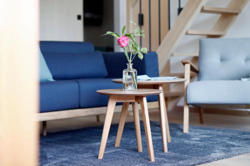 a vase of flowers on a table in a living room at Alpin Chalet Trinkl - adults only ab 16 Jahren in Bad Wiessee