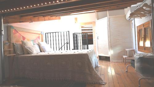 a bedroom with a large bed with white pillows at Casa Rural Antigua Botica in Torremocha de Jarama