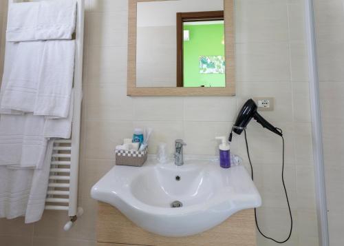 a bathroom sink with a blow dryer and a mirror at LA CASA DI MAMMA 'NTO in Castrofilippo