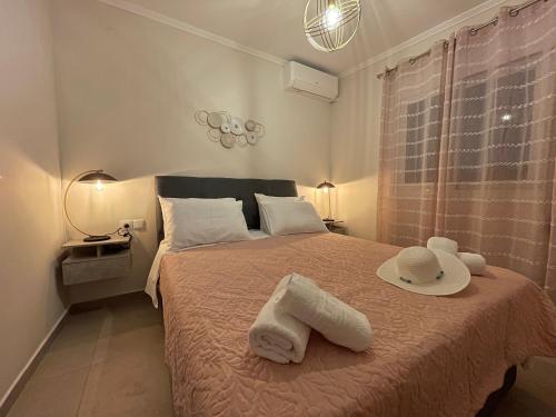 a bedroom with a bed with towels on it at Averto House Lefkada in Lefkada Town