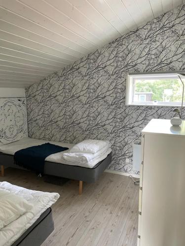 a bedroom with a bed and a stone wall at Villa Båthamnsgatan in Söråker