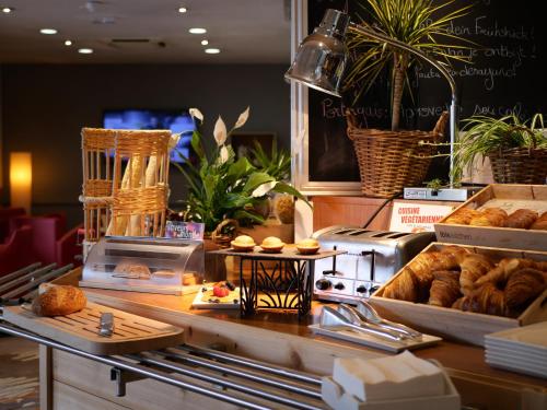 a bakery with pastries and breads on a counter at ibis Nemours in Nemours