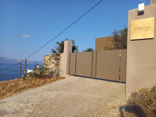 a row of gates on the side of a building at Athena s House in Platia Ammos